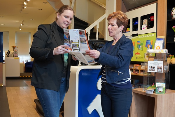VVV Roermond employee helps a customer by showing something on the map